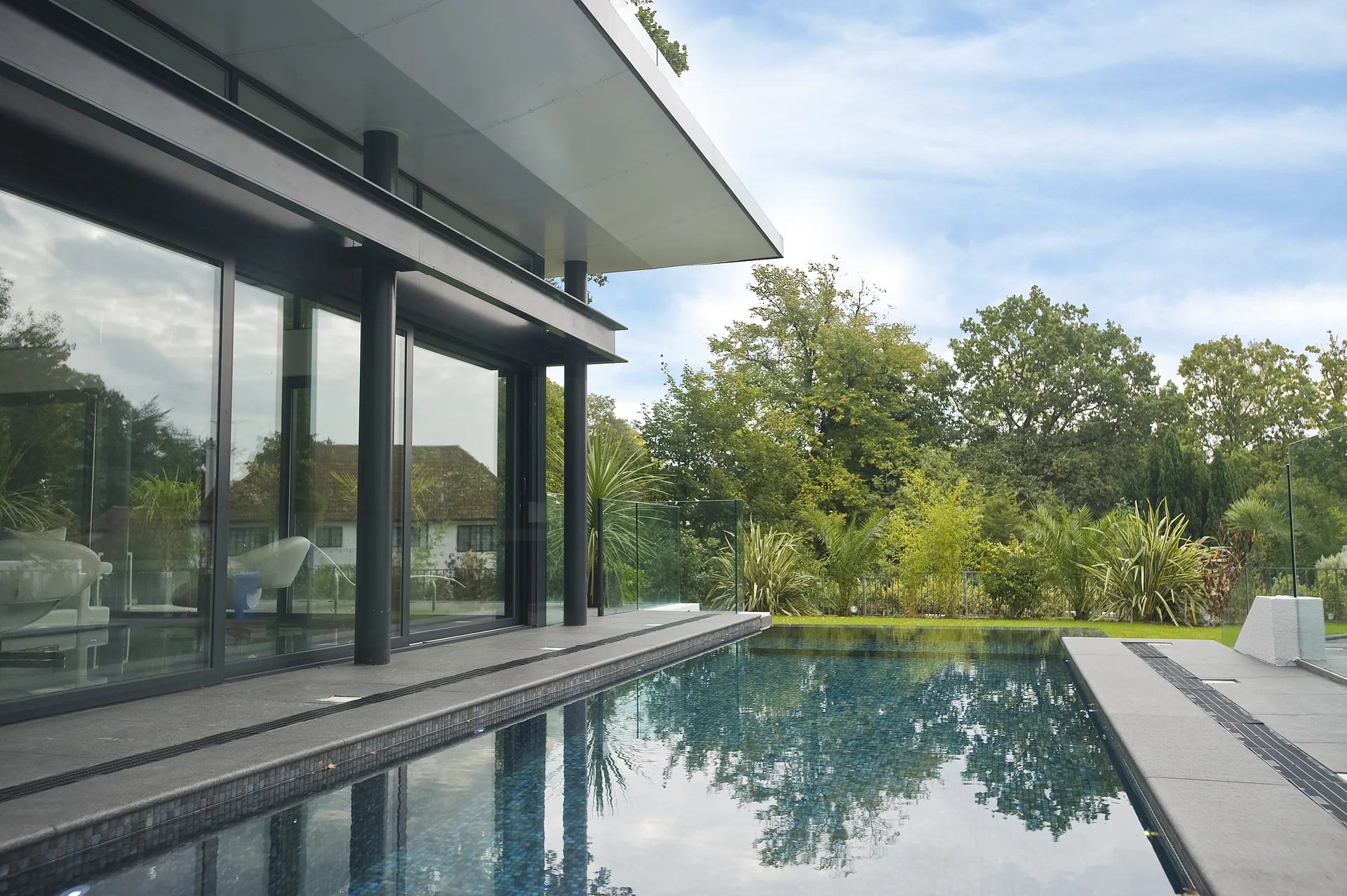 Outdoor infinity pool and landscaped terrace, completed by Morgan Design & Construction in Branksome Park, Poole