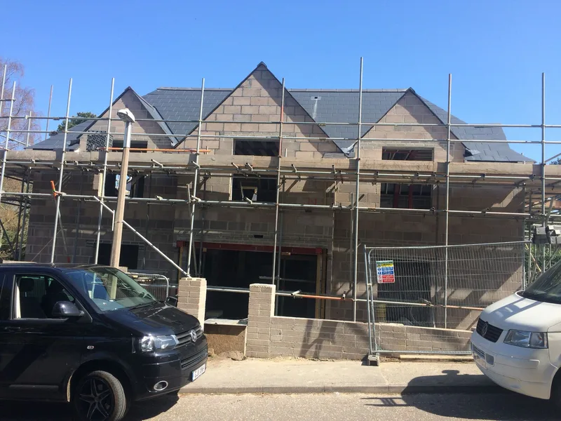 New build home under construction on scaffolding, built to client-supplied plans — Morgan Design & Construction